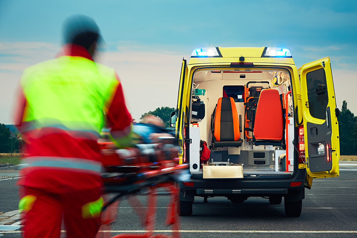 Emergency medical service Emergency medical service. Paramedic is pulling stretcher with patient to the ambulance car.